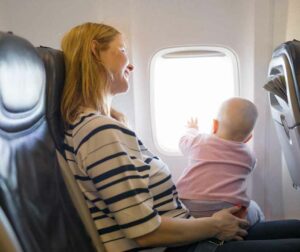 Baby looking out of the window in a plane